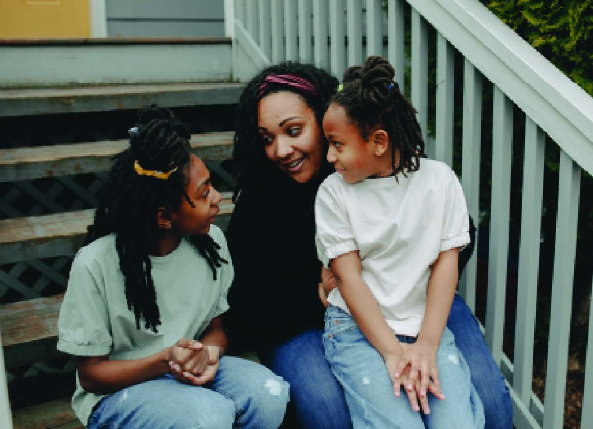 An image of three people talking on a staircase on a web page about Kids Help Phone’s mental health website
