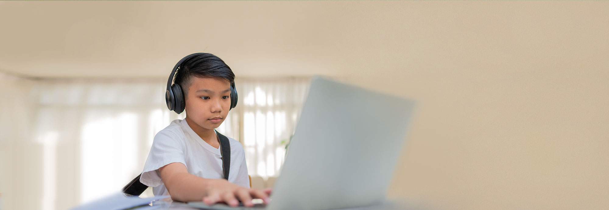 A young person exploring mental health activities for kids on a laptop