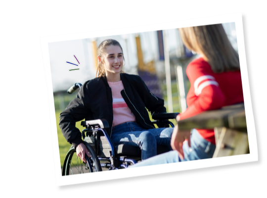 Young people in wheelchairs talking outside
